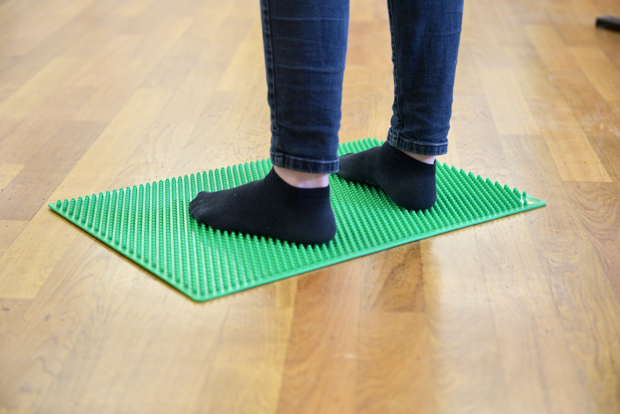 Standing on a studded rubber mat